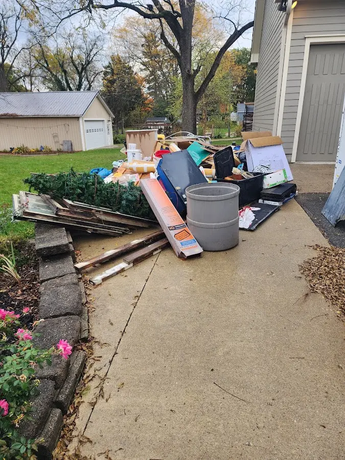 Dumpster being loaded with debris for Estate Cleanout Dumpster Rental in Wright City
